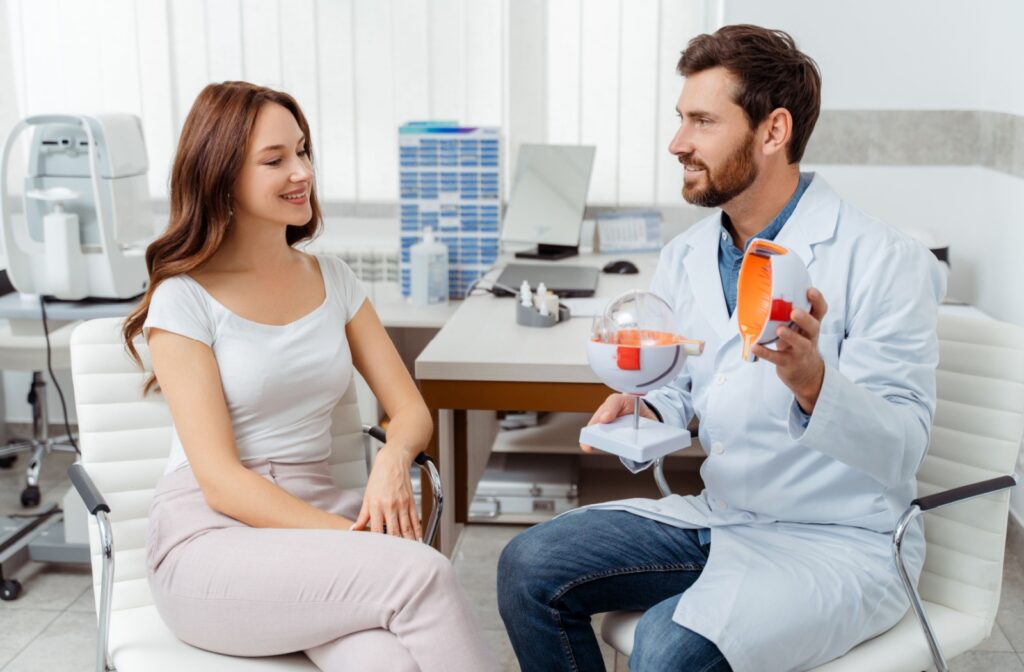 A young woman discusses her laser surgery options with her optometrist during her refractive surgery consultation.