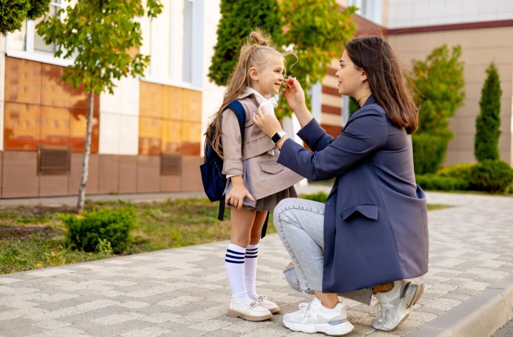 A parent dropping their child off at school.