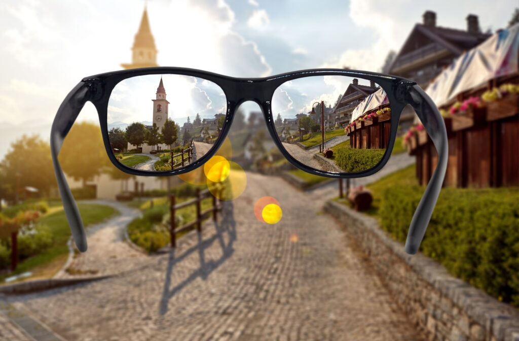 A view through black-rimmed vision glasses with anti-glare glass of a small, beautiful city.