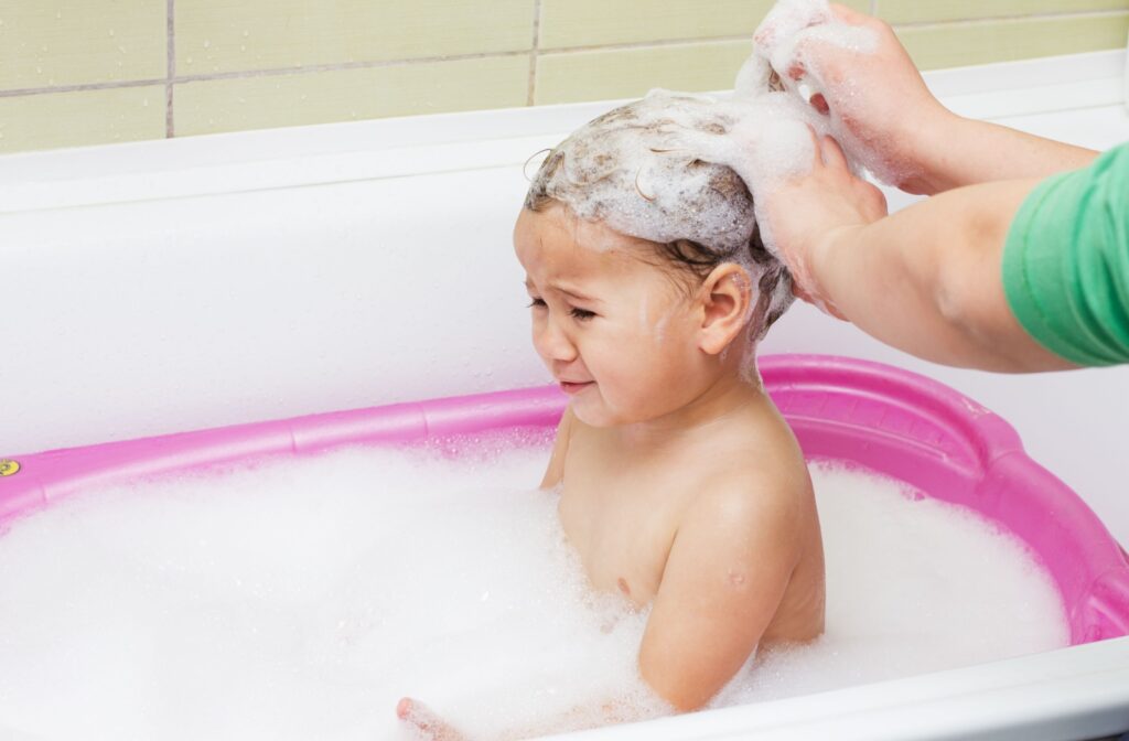 Crying child during bathing and washing hair.