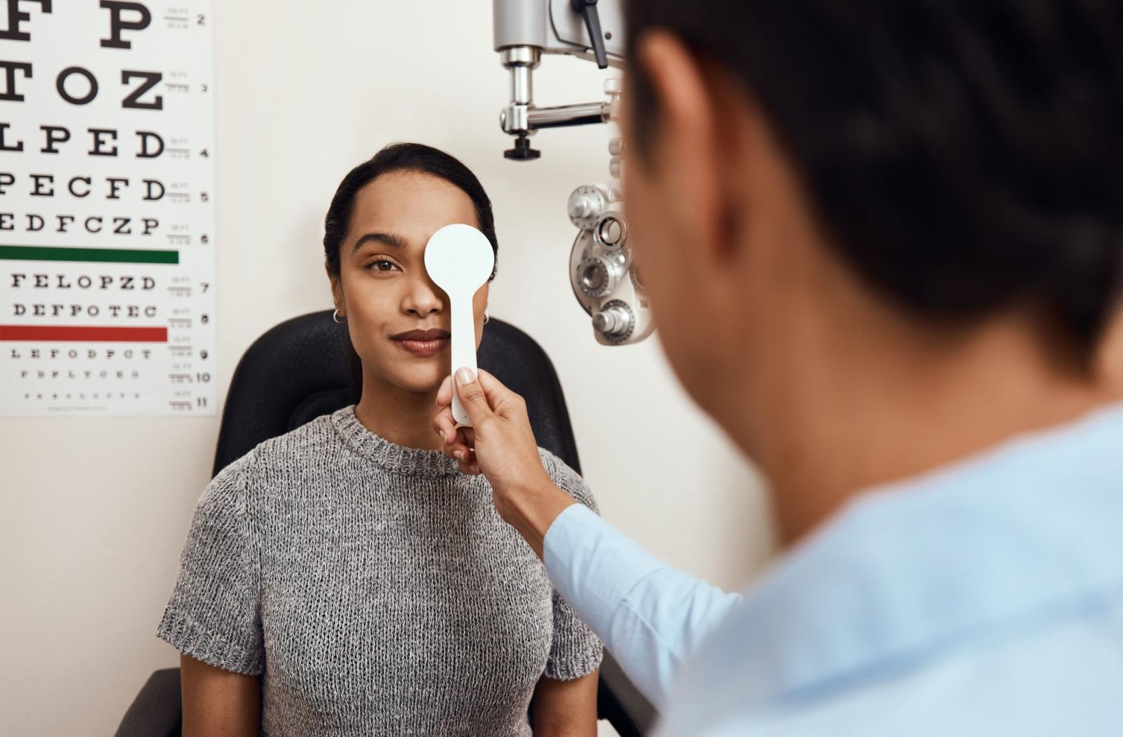 A patient having their visual acuity tested during an eye exam to ensure their prescription is up-to-date.